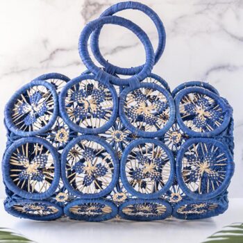 Santorini Sprinkles Havana Macrame' Straw Bag by Shebobo Against a Marble and Clean White Background with Palm Leaves