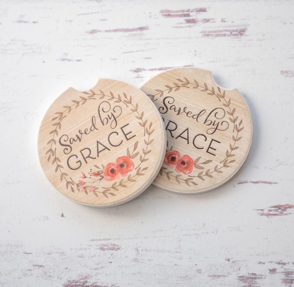 CounterArt & Highland Home Saved by Grace car coaster set with colorful flower art and sitting on top of a white rustic wood background
