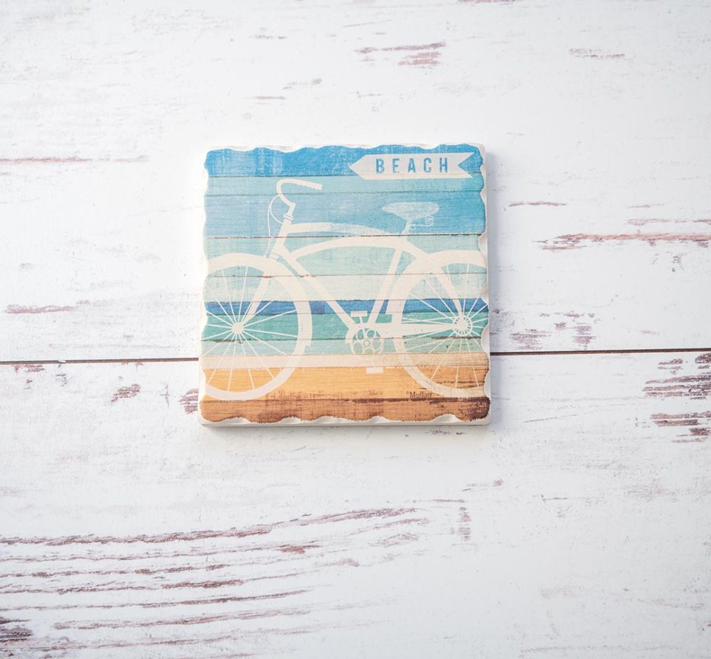 CounterArt & Highland Home Beachscapes bicycle coaster on a white rustic wood background