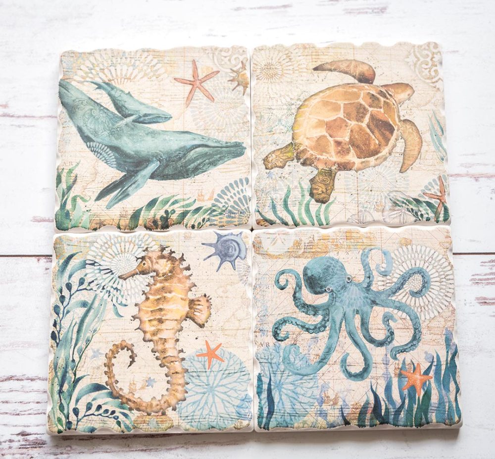 CounterArt & Highland Home Nautical Ocean Life coaster set sitting side by side on a white rustic wood background