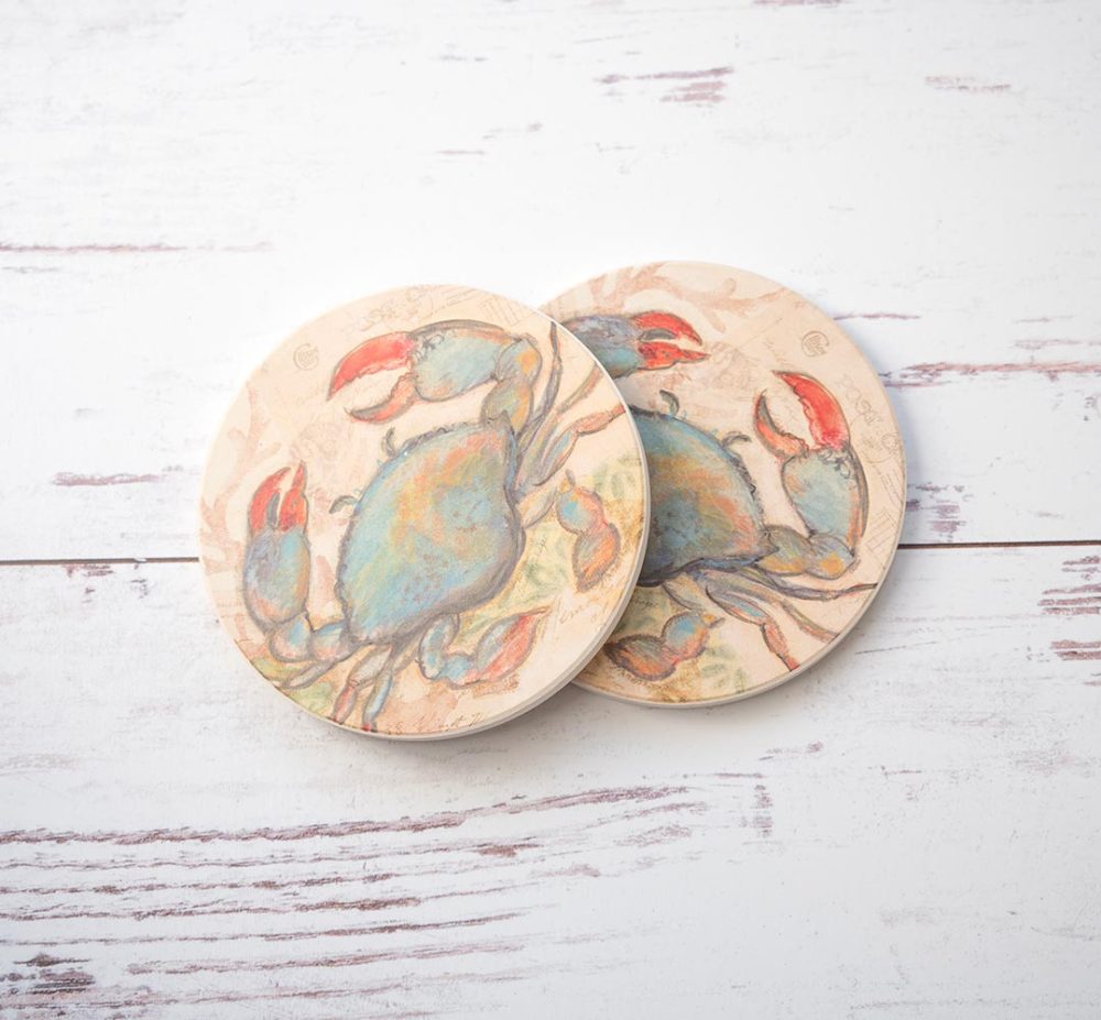 CounterArt & Highland Home Seaside Blue Crab coaster set of 2 with colorful blue crab and sitting on top of a white rustic wood background