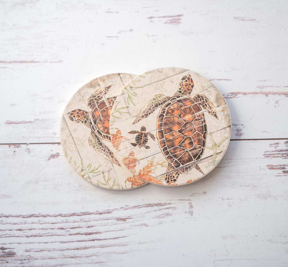 CounterArt & Highland Home Seaside Blue Crab coaster set of 2 with colorful blue crab and sitting on top of a white rustic wood background