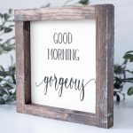Angled View of the Joshua Jar Good Morning Gorgeous wood sign against a white backdrop and greenery