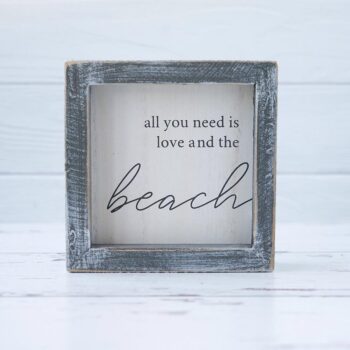 Front View of the All You Need is Love and the Beach Wooden Accent Sign by Gia Roma on a Rustic White Wood Background