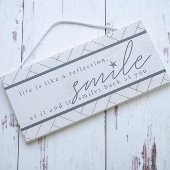 Top View of the Life is Like a Reflection Wooden Accent Sign by Gia Roma Against a Rustic Wooden Backdrop