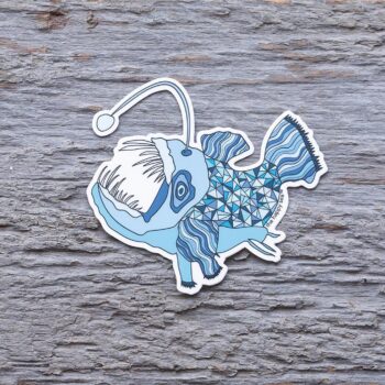 Anglerfish Die-Cut Vinyl Sticker by the Happy Sea on a Weathered Rustic Piece of Wood