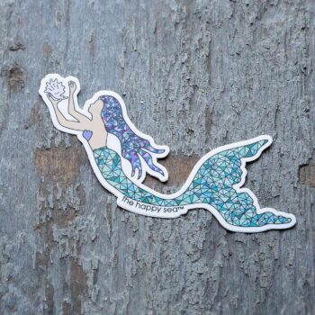 4" Die-Cut Mermaid Sticker by the Happy Sea Against a Rustic Wood Background