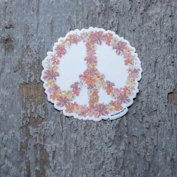 3" Die-Cut Hibiscus Peace Sign Sticker by the Happy Sea Against a Rustic Wood Background