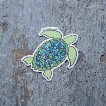 3" Die-Cut Sea Turtle Sticker by the Happy Sea Against a Rustic Wood Background