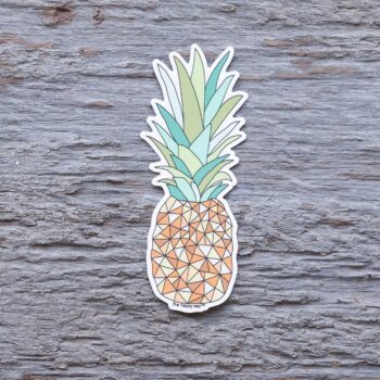 Pineapple Die-Cut Vinyl Sticker by the Happy Sea on a Weathered Rustic Piece of Wood