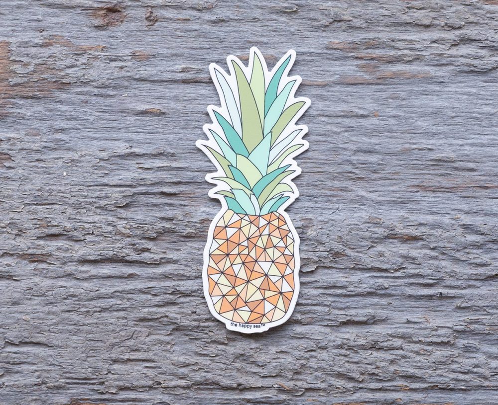 Pineapple Die-Cut Vinyl Sticker by the Happy Sea on a Weathered Rustic Piece of Wood