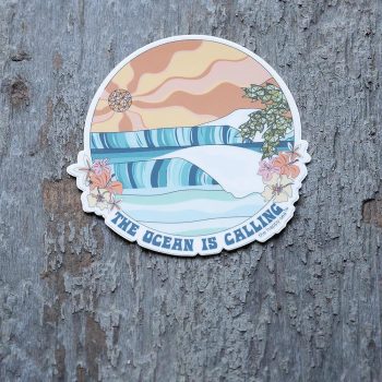 4" Die-Cut The Ocean is Calling Sticker by the Happy Sea Against a Rustic Wood Background