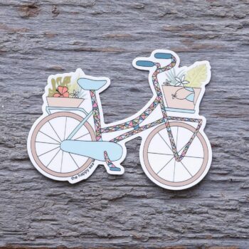 Sea Tropicalia Bicycle Die-Cut Vinyl Sticker by the Happy Sea on a Weathered Rustic Piece of Wood