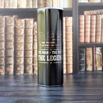 Front view of the Dad - the Myth - the Legend Camouflage skinny tumbler by Emma K designs on a office type background with books