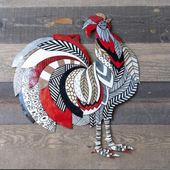 Top View of the Colorful Rooster Steel Drum Wall Art Piece by Papillon Marketplace on a Wood Background