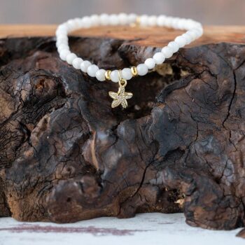 Lenny & Eva Wanderlust Starfish Bracelet resting on a piece of wood with a rustic background