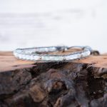 Lotus & Luna When the Stars Align Moonstone bracelet laying on a piece of wood with white rustic wood background