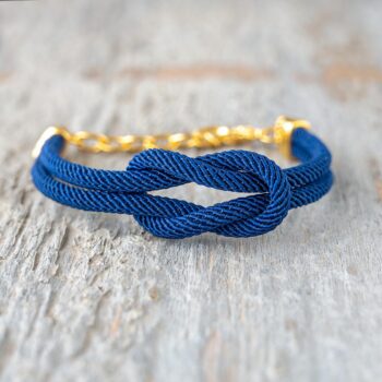 Maris Sal Nautical Providence Nautical Knot Women's Bracelet in Gold-Plated Stainless Steel on a Rustic Weathered Piece of Wood
