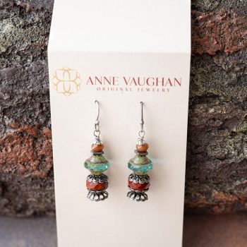 Lakeside Czech Glass Earrings by Anne Vaughn Designs with Branded Tag Against a Piece of Rustic Wood