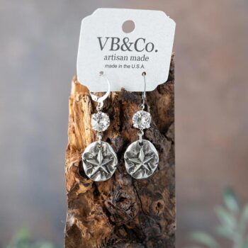 Starfish Earrings with Swarovski Crystals by VB&CO Designs Hanging on a Piece of Wood