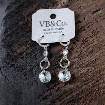 Top View of the VB&CO Designs Light Azure Swarovski Earrings on a Dark Piece of Wood