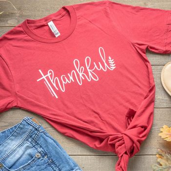 Thankful Women's Graphic Tee by Humm & Willow on a Wooden Backdrop with Shorts & Sandals