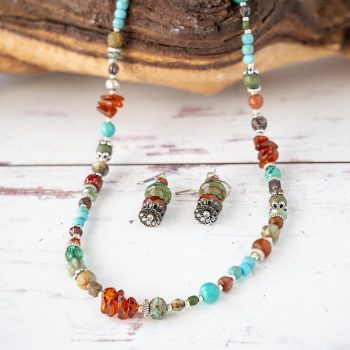 Lakeside Collecxtion Earrings and Necklace by Anne Vaughn Designs on a Piece of Wood and Rustic White Background