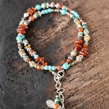 Top View of the Anne Vaughn Designs Lakeside Jasper Collage Bracelet Folded as a Bracelet on a Dark Piece of Wood