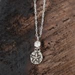 Top View of the Starfish Necklace with Swarovski Crystals by VB&CO Designs on Dark Wood