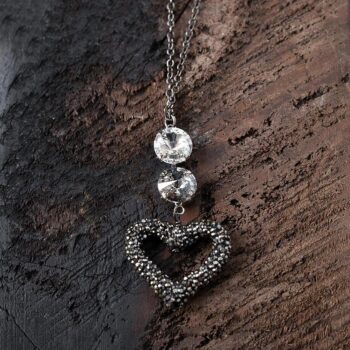 Top View of the Swarovski Crystal Heart Necklace on a dark wood background