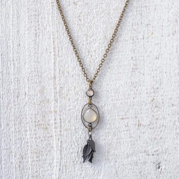 Angled View of the VB&CO Designs Rustic Moonstone Celestial Leaf Boho Necklace on a White Rustic Piece of Wood