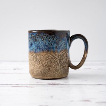 White Squirrel Clayworks stoneware ceramic coastal shores coffee mug on white top with rustic white wood background