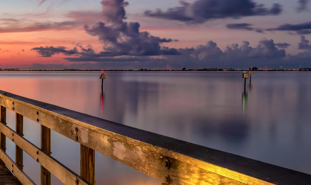 Left railing closeup of Welcome to Morning a Safety Harbor Pier sunrise photograph taken a few moments before sunrise with a colorful scene