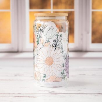 Front View of the Fall Floral Glass Tumbler Against a Fall Scene Window and on Rustic Wood