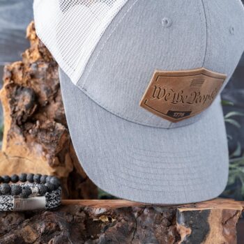 Dark to Light Collection of the RANGE Leather America Established Hat with the pairing of the Steel & Barnett Stones Beaded bracelet and Rope Lake bracelet on Wood and Dark Wood Background