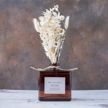 White Tea & Pampas Bouquet Reed Diffuser on a rustic and white wood background