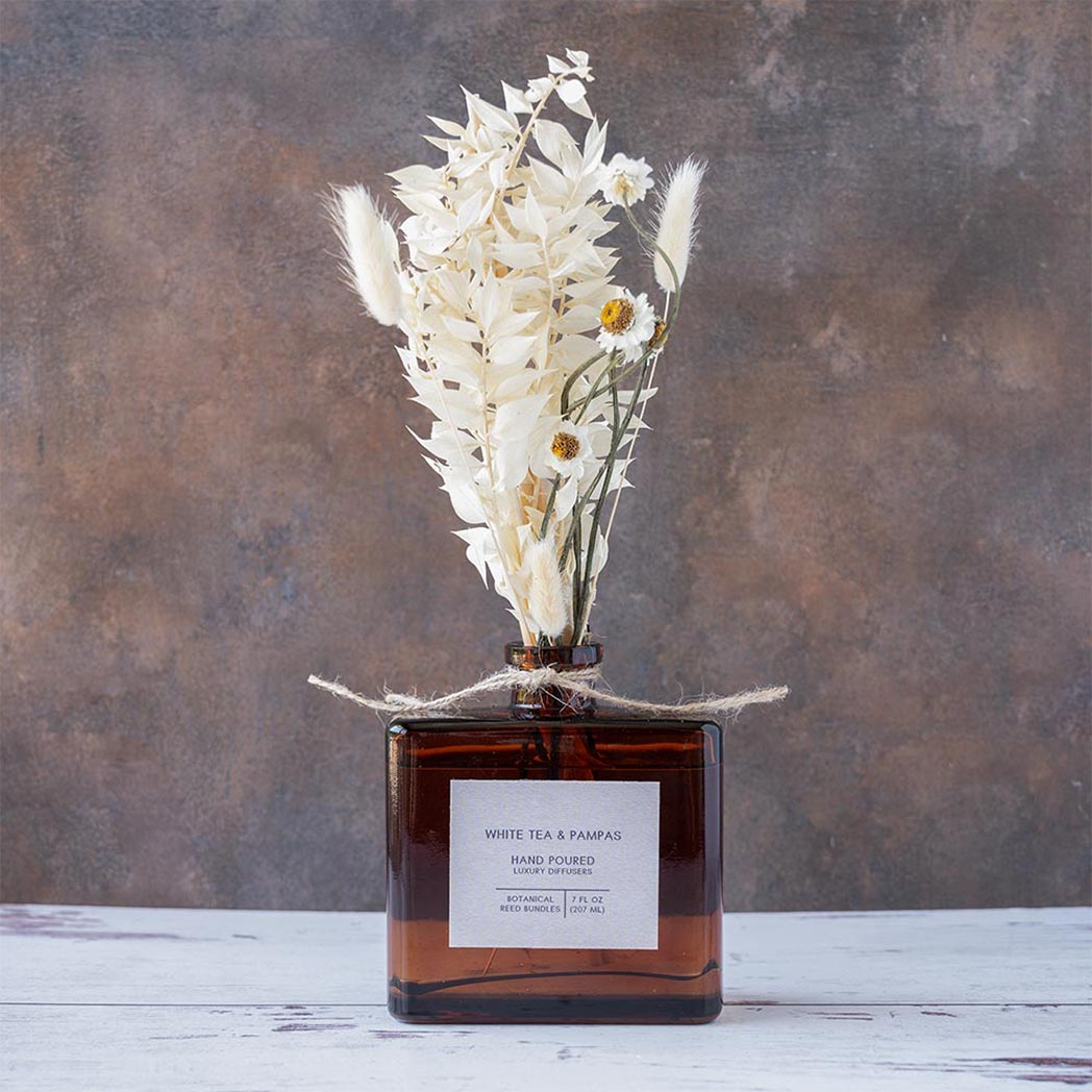 White Tea & Pampas Bouquet Reed Diffuser on a rustic and white wood background