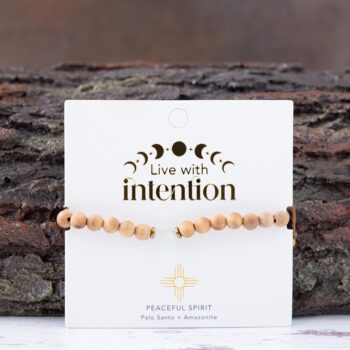 Peaceful Spirit Palo Santo Bracelet with Lotus & Luna branded card against a rustic piece of wood