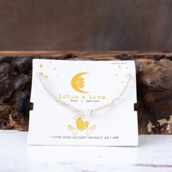 Sparkling Shores Crystal Necklace AGainst a Rustic Piece of Wood