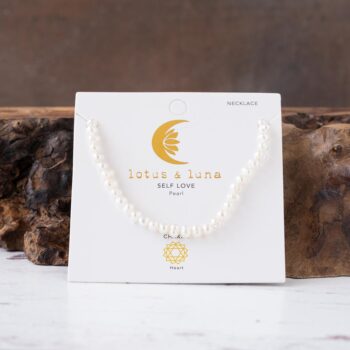 Sugary Sands Self Love Pearl Necklace AGainst a Rustic Piece of Wood
