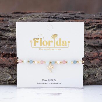 The Always Sunny in Florida charm bracelet against a textured piece of wood
