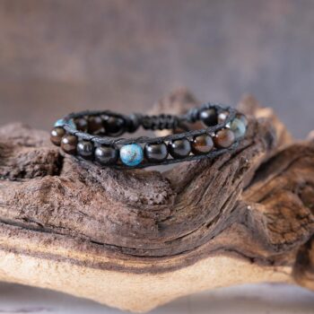 Men's King Triton beaded bracelet front view resting on a rustic piece of wood