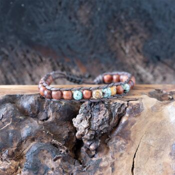 Men's Salty Grom beaded bracelet front view resting on a rustic piece of wood