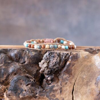 Men's Southern Coastal beaded bracelet front view resting on a rustic piece of wood