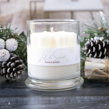 Front view of the Live Young Candle Co Fallen Snowflake snowflake candle against a rustic wintery Christmas background