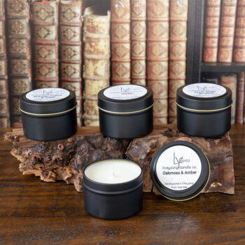 Live Young Candle Co Tin Can Candle Collection on a Rustic piece of Wood against a rustic office desk background