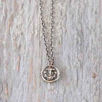 Front view of the Johnny Ltrd Anchored men's necklace against a rustic white wood background