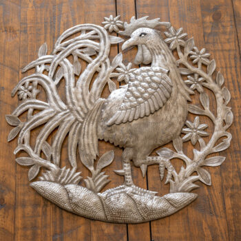 Top view of the Roosters Garden wall decor piece against a dark rustic piece of wood