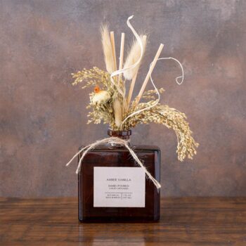 Amber Vanilla Bouquet Reed Diffuser against a rustic background