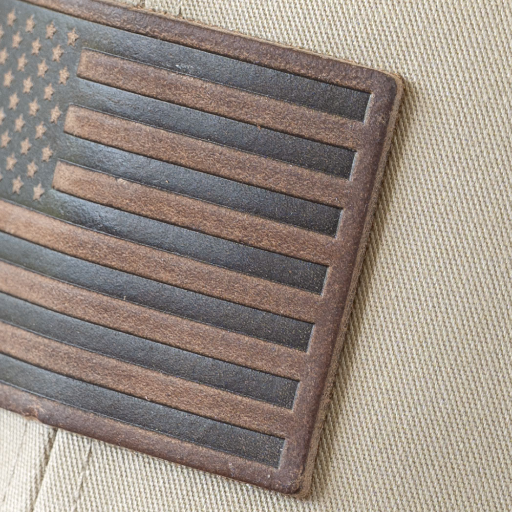 Closeup of the American Flag leather patch on the RANGE Leather American Flag leather patch hat in the color tan